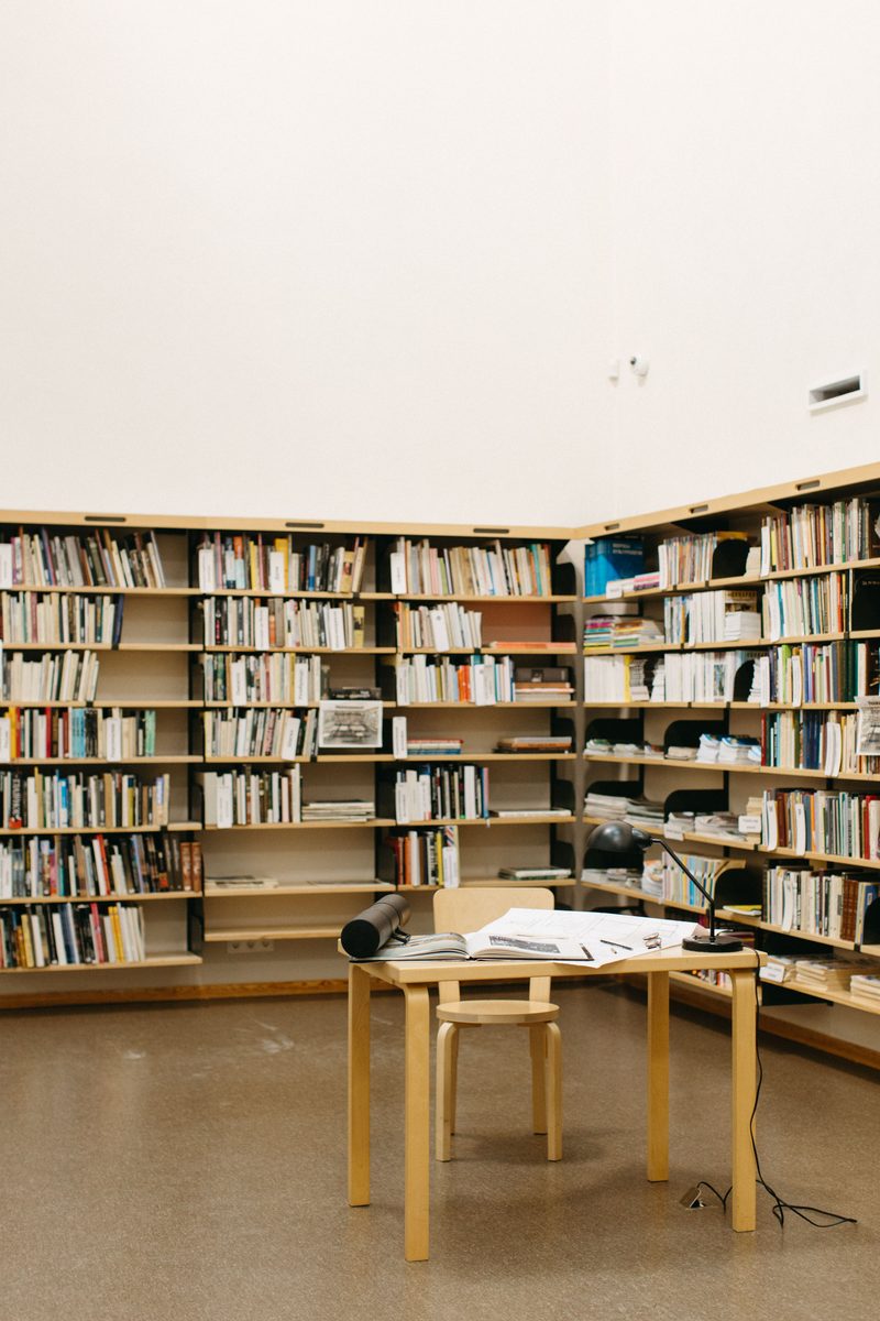 A library corner: shelves of books around a small reading desk