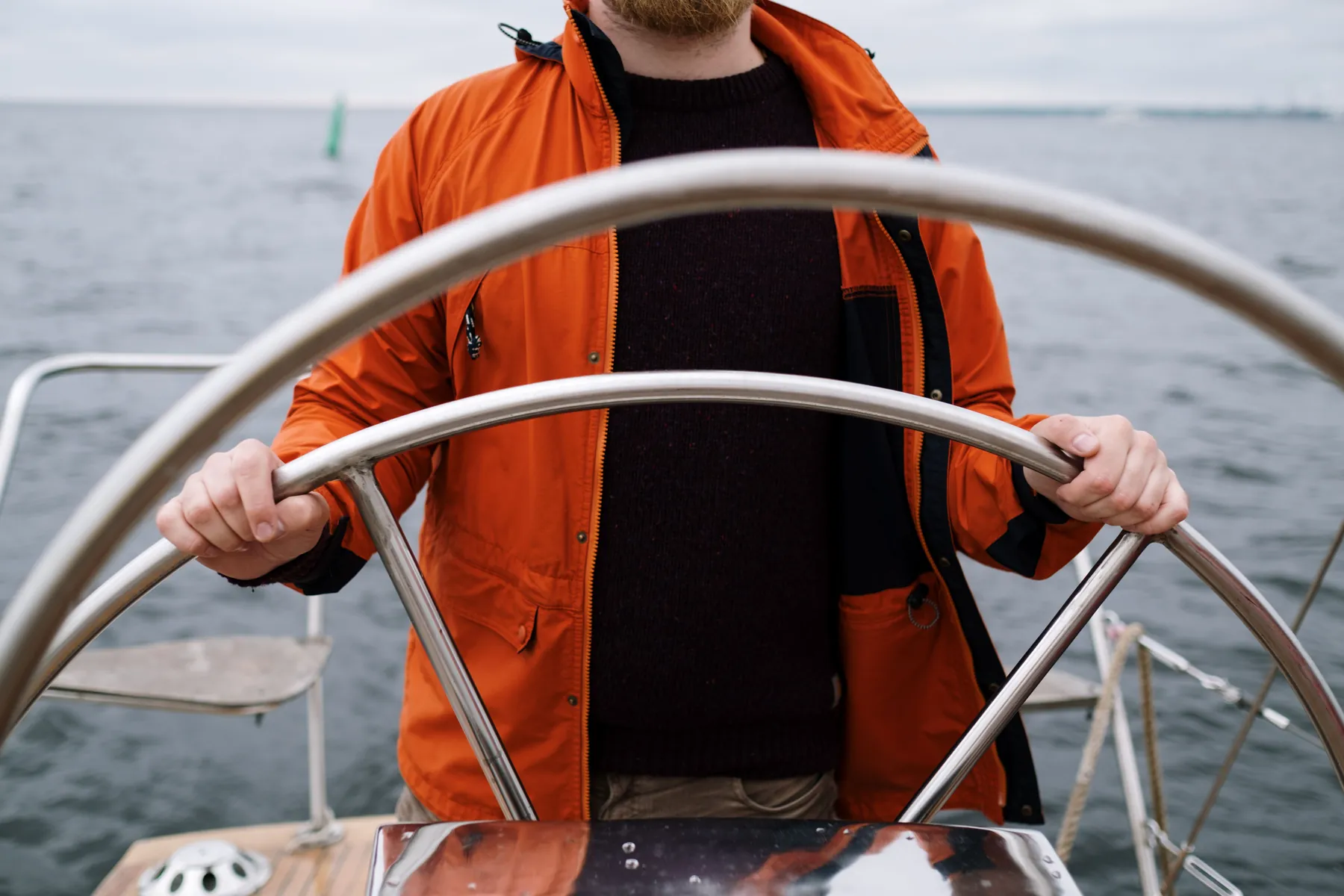 A hand on the helm: the sea supplies the swerve, the hand supplies the choice. Photograph by cottonbro studio, Pexels.