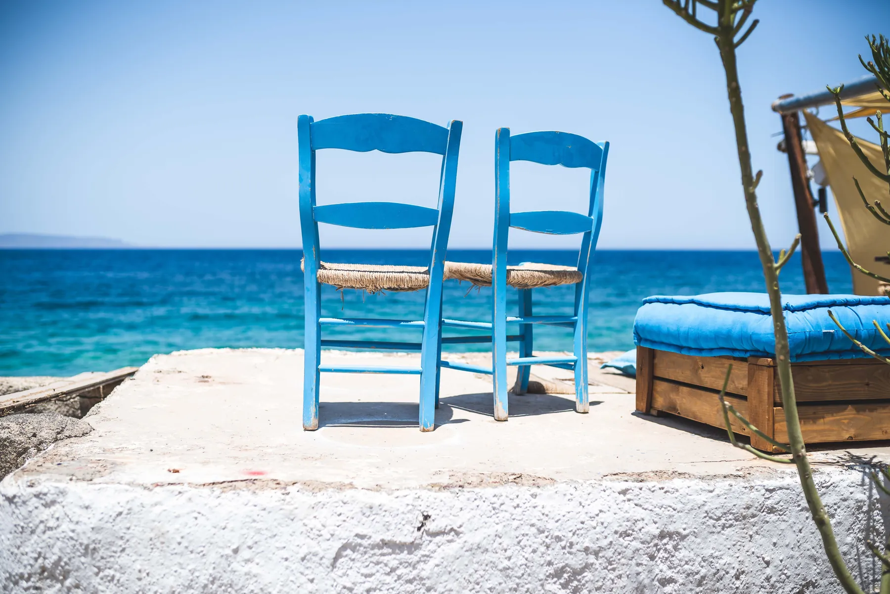 Two empty chairs facing the sea. Photograph: Alex Staudinger, Pexels.
