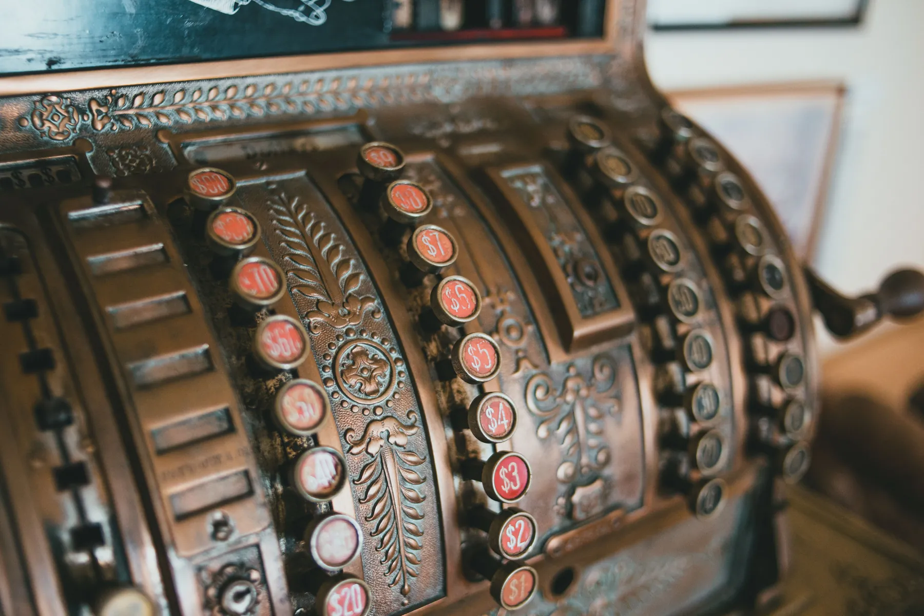 An antique cash register. The question it raises is older than the machine: how much money to keep at hand, and how much to put to work. Photograph by Erik Mclean, Pexels.