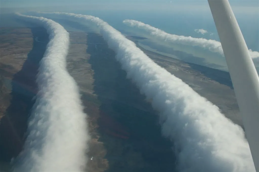 The Morning Glory near Burketown, Queensland, seen from a plane, 11 August 2009: several roll clouds, one behind another, like the waves of a bore. Photograph: Mick Petroff, CC BY-SA 3.0, via Wikimedia Commons.
