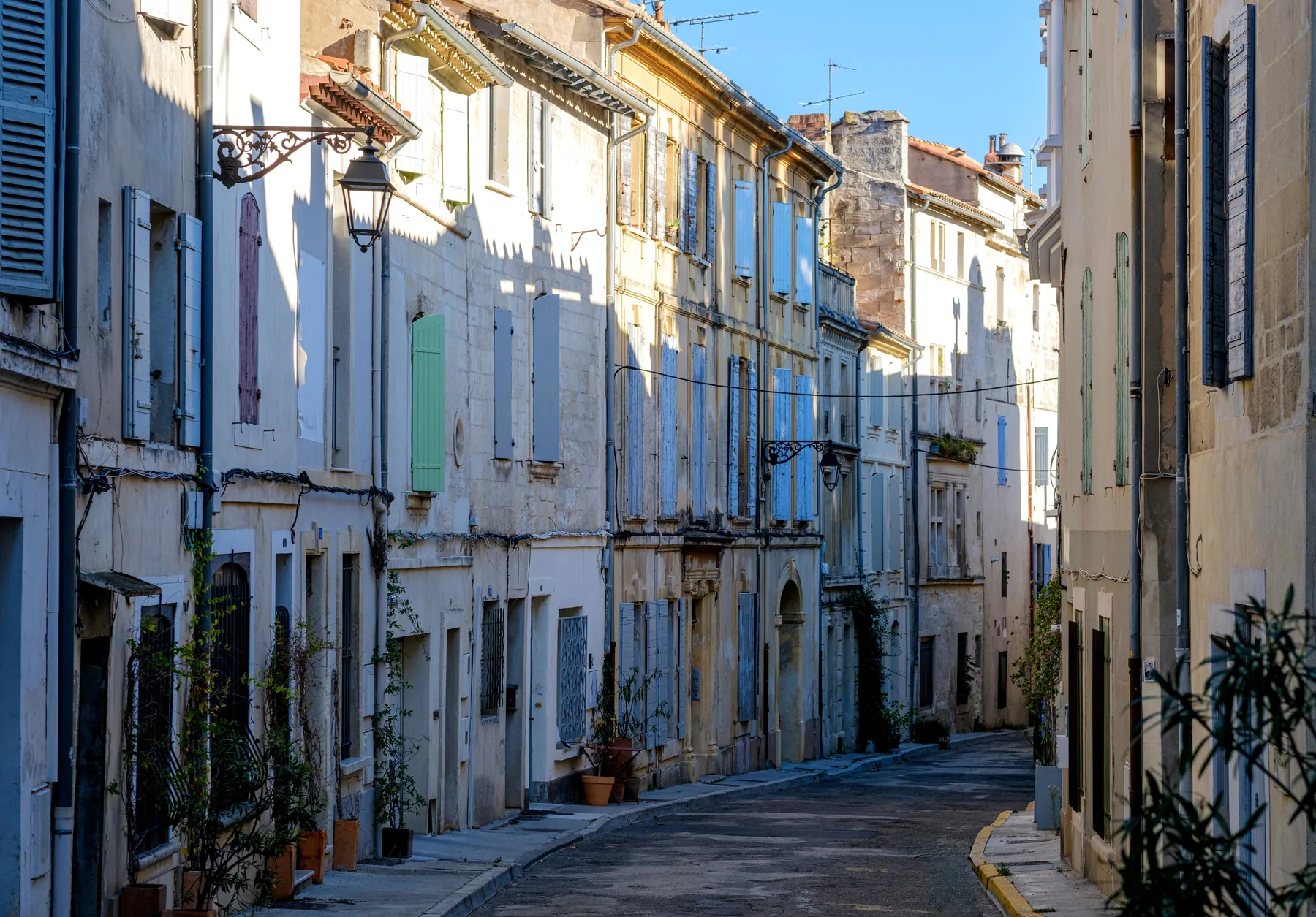 A quiet street of old houses and shutters in Arles.