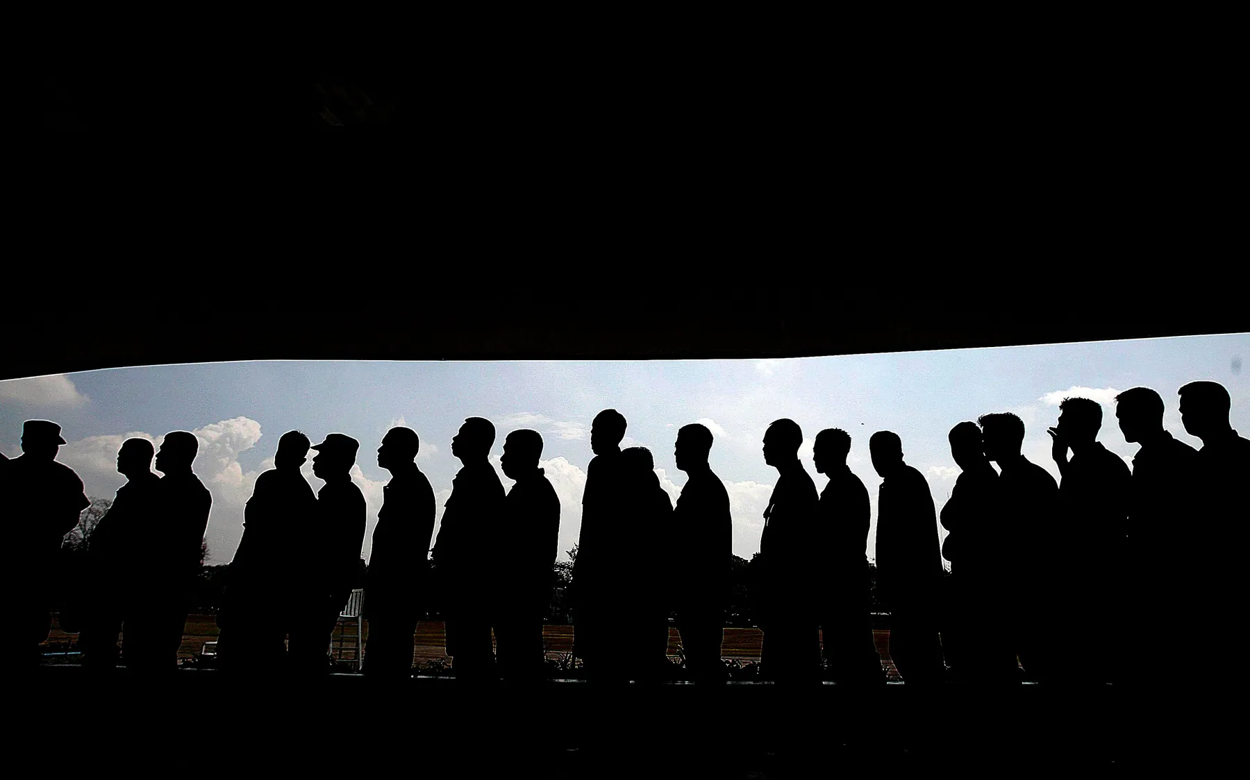 A queue in silhouette. Every queue has a size at which as many join as leave; one whose arrivals flatten and whose cancellations steepen as it grows rests below that size. Photograph by Krizjohn Rosales, Pexels.